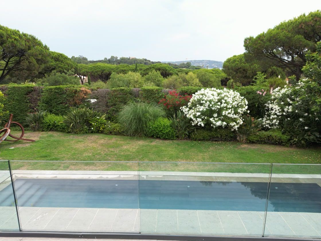 Pool and sculpture lawn behind glass